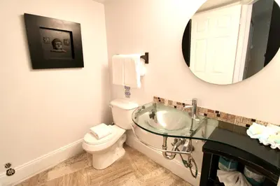 a bathroom with a sink and a toilet and a mirror at Castle L1 Double-Loft Condo with Beach Access, Pool, Tennis and Free Parking! in Miami Beach