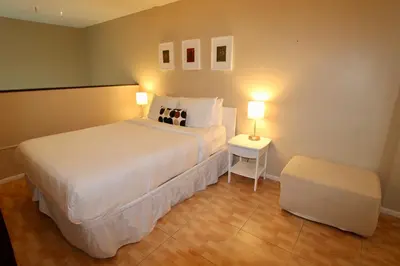 a bedroom with a large white bed and two lamps at Castle L1 Double-Loft Condo with Beach Access, Pool, Tennis and Free Parking! in Miami Beach