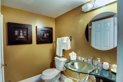 a bathroom with a sink and a toilet and a mirror at Castle L1 Double-Loft Condo with Beach Access, Pool, Tennis and Free Parking! in Miami Beach