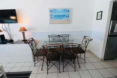 a dining room table with chairs and a kitchen at Castle Th14 in Miami Beach