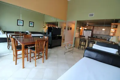 a living room with a table and chairs and a kitchen at Castle B17 Contemporary Condo with Pool, Beach Access and Free Parking in Miami Beach