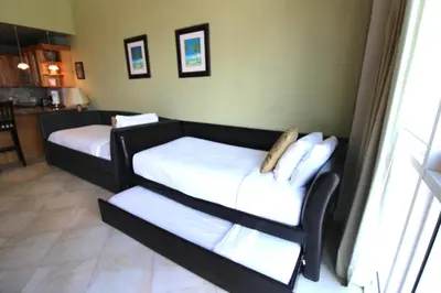a room with two beds with white sheets at Castle B17 Contemporary Condo with Pool, Beach Access and Free Parking in Miami Beach