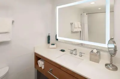 a bathroom with a sink and a mirror at DoubleTree by Hilton Miami North I-95 in Miami