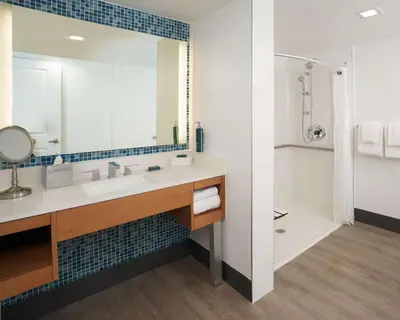 a bathroom with a sink and a mirror at DoubleTree by Hilton Miami North I-95 in Miami
