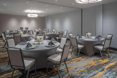 a conference room with tables and chairs and tablesktop at DoubleTree by Hilton Miami North I-95 in Miami