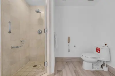 a bathroom with a shower and a toilet at Steps to the Sand Beachfront Escape- 25th Floor Views in Miami Beach
