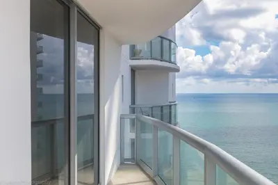 a view of the ocean from the balcony of a building at Steps to the Sand Beachfront Escape- 25th Floor Views in Miami Beach