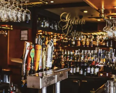 a bar with a lot of bottles of alcohol at Riverside Hotel in Fort Lauderdale