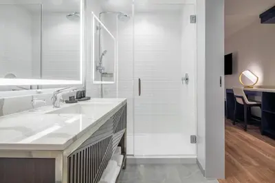 a white bathroom with a sink and a shower at Hyatt Centric Las Olas Fort Lauderdale in Fort Lauderdale
