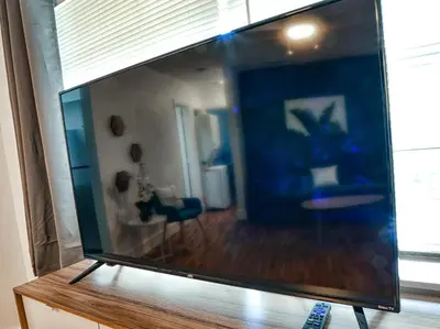 a large screen tv sitting on top of a table at Broadwaysuites Downtown By RocketStay in Miami