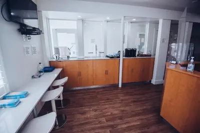 a kitchen with wooden cabinets and a counter top at The Drift Hotel in Fort Lauderdale