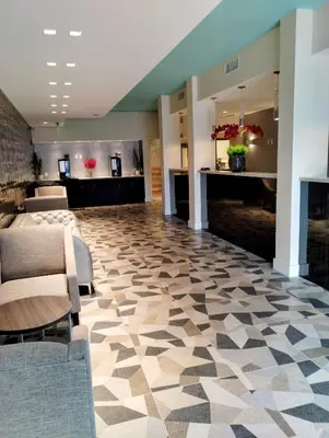 a hotel lobby with a checkered floor at Red Carpet Inn Airport Fort Lauderdale in Fort Lauderdale