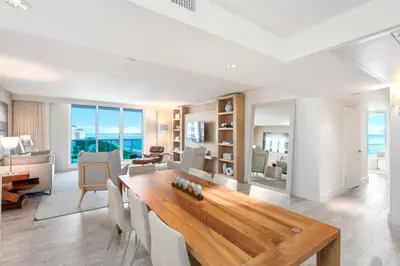 a dining room with a table and a living room at Oceanfront Private Condo at 1 Hotel & Homes -1219 in Miami Beach