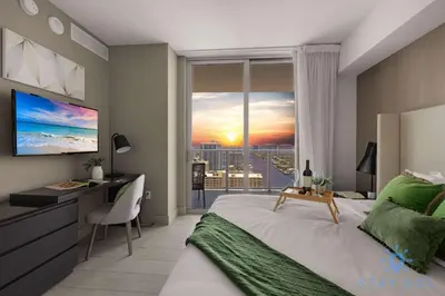 a bedroom with a bed and a desk and a window at Wrap Around Balcony - Insane Views - Amazing Pools in Hollywood