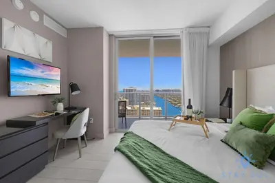 a bedroom with a bed and a desk and a window at Wrap Around Balcony - Insane Views - Amazing Pools in Hollywood