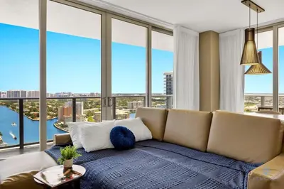 a living room with a couch and large windows at Luxury 3 Br- Front Intercostal View - Amazing Pools in Hollywood