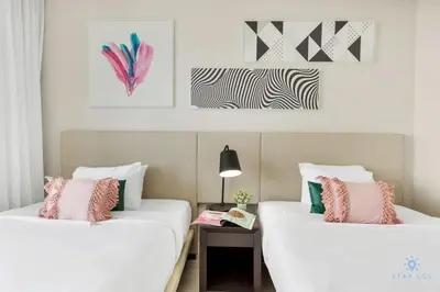 two beds in a room with white and pink pillows at Luxury 3 Br- Front Intercostal View - Amazing Pools in Hollywood