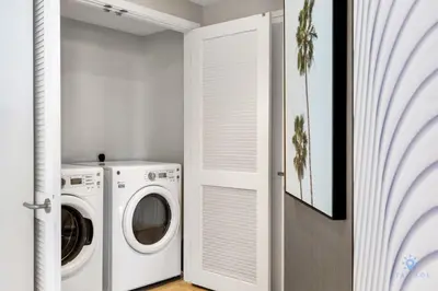 a white laundry room with a washer and dryer at Luxury 3 Br- Front Intercostal View - Amazing Pools in Hollywood