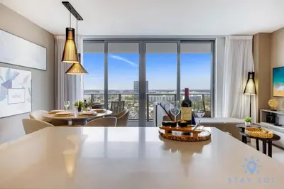 a living room with a table with a bottle of wine at Luxury 1Br-Front Intracoastal View Balcony - Pools in Hollywood