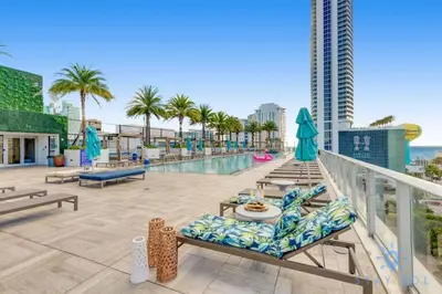 a balcony with a swimming pool and palm trees at Wrap Around Balcony - Paradise Beach - Amazing Pools in Hollywood