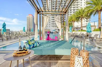 a hotel pool with a bed and a table at High-Floor with Stunning Views-Luxury Condo - Pools in Hollywood