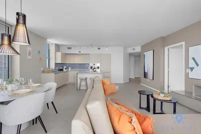 a living room and kitchen with a couch and a table at Luxury 2Br Front Ocean & Bay View, Amazing Pools in Hollywood