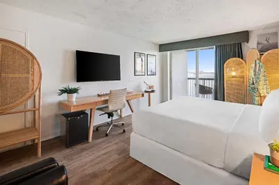 a hotel room with a bed and a desk at Palm Tree Club Miami in Miami Beach