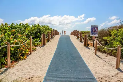 a path through the sand on the beach at Welworth condo units Miami Beach in Miami Beach
