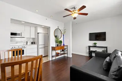 a living room with a couch and a ceiling fan at Welworth condo units Miami Beach in Miami Beach