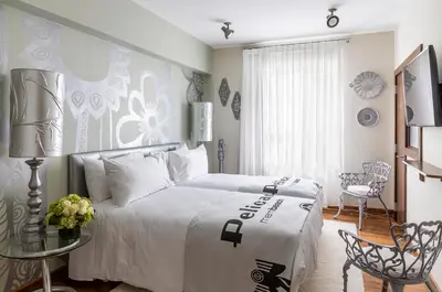 a bedroom with a bed with a white bedspread at Pelican Hotel in Miami Beach