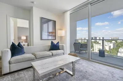 a living room with a couch and a large window at 914 Tiffany House condo in Fort Lauderdale