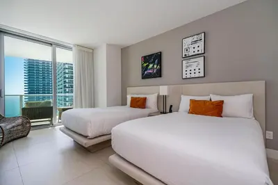 a bedroom with two beds and a large window at Amazing views on the 29th floor 2BR Beach Resort in Hallandale Beach