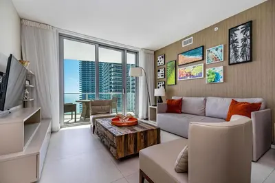 a living room with a couch and a tv at Amazing views on the 29th floor 2BR Beach Resort in Hallandale Beach