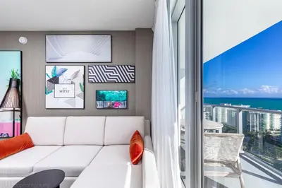 a living room with a white couch and a view of the ocean at Hyde Beach House Hollywood Private Suites in Hollywood