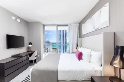 a bedroom with a large bed and a large window at Hyde Beach House Hollywood Private Suites in Hollywood