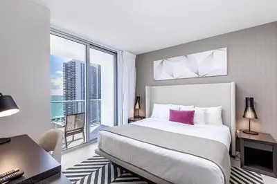a bedroom with a large bed and a large window at Hyde Beach House Hollywood Private Suites in Hollywood
