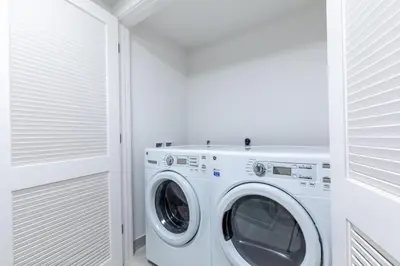 a white laundry room with a washer and dryer at Hyde Beach House Hollywood Private Suites in Hollywood