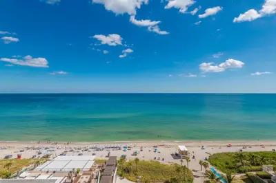 a view of the beach from the balcony of a resort at Relaxing Getaway with Intracoastal Views in Hollywood