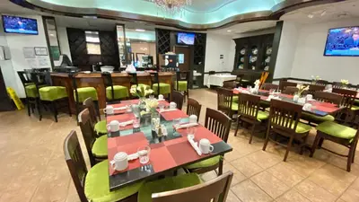 a restaurant with tables and chairs and a bar at Seacoast by Miami Ambassadors in Miami Beach