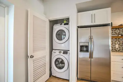 a kitchen with a refrigerator and a washer and dryer at Modern Home with Shared Pool in Fort Lauderdale! in Fort Lauderdale