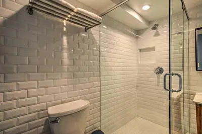 a bathroom with a toilet and a glass shower at Modern Home with Shared Pool in Fort Lauderdale! in Fort Lauderdale