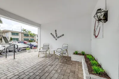 a group of chairs sitting on a patio at Ft Lauderdale Apt with Pool - 1 Mi to Beach Access! in Fort Lauderdale