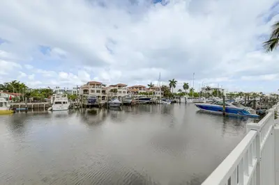 a marina with boats in the water next to houses at Ft Lauderdale Apt with Pool - 1 Mi to Beach Access! in Fort Lauderdale