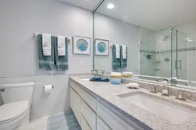 a white bathroom with a toilet and a sink at Waterfront Fort Lauderdale House with Heated Pool! in Fort Lauderdale