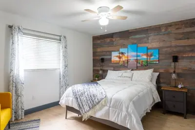 a bedroom with a bed and a wooden wall at Casa Madeira @ the heart of Miami Design District in Miami