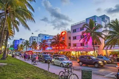 a busy city street with cars and buildings and palm trees at Lakeside Vacation Home in Davie