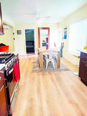 a kitchen with a table and a stove and a dining room at Family, Couples Retreat near Airport, Cruise Port & Beaches in Fort Lauderdale