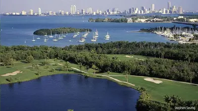 an aerial view of a golf course with a large body of water at Gorgeous Beachy Chic Condo in Key Biscayne in Miami