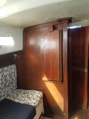 a small room with a chair and a wooden door at Unique perspective in Miami