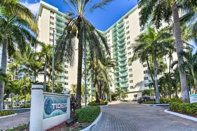 a palm tree lined street in front of a building at Beachfront Condo with Pool Access in Hollywood! in Hollywood